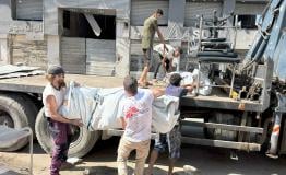 Five MEDSF staff load tents on to a truck in Gaza City
